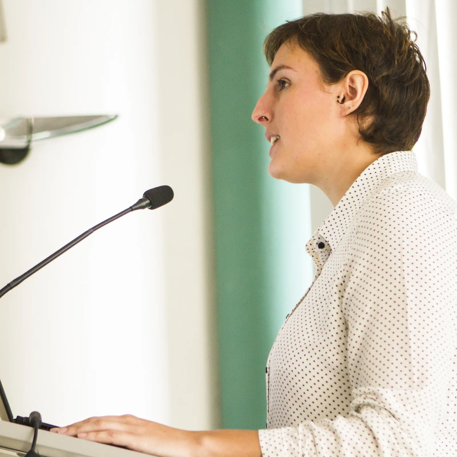 A doctoral candidate standing at a podium during her thesis defense