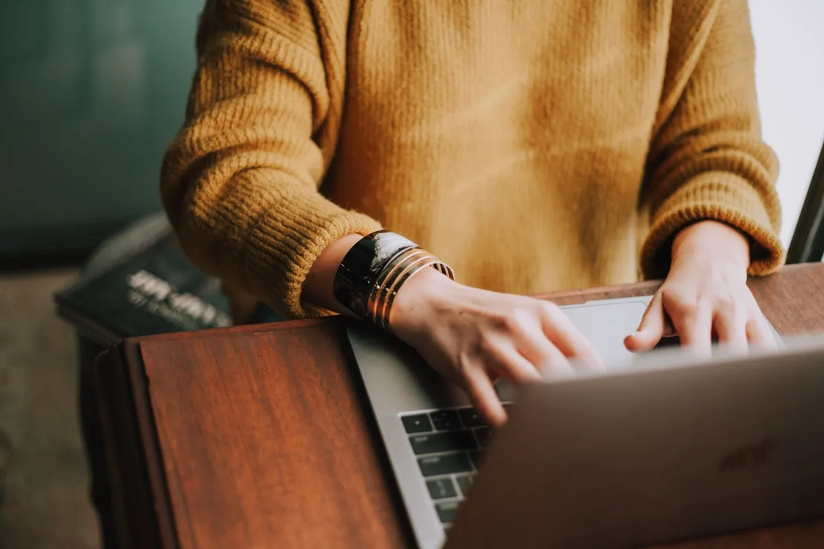 Person using voice typing on laptop -dyslexia writing tools