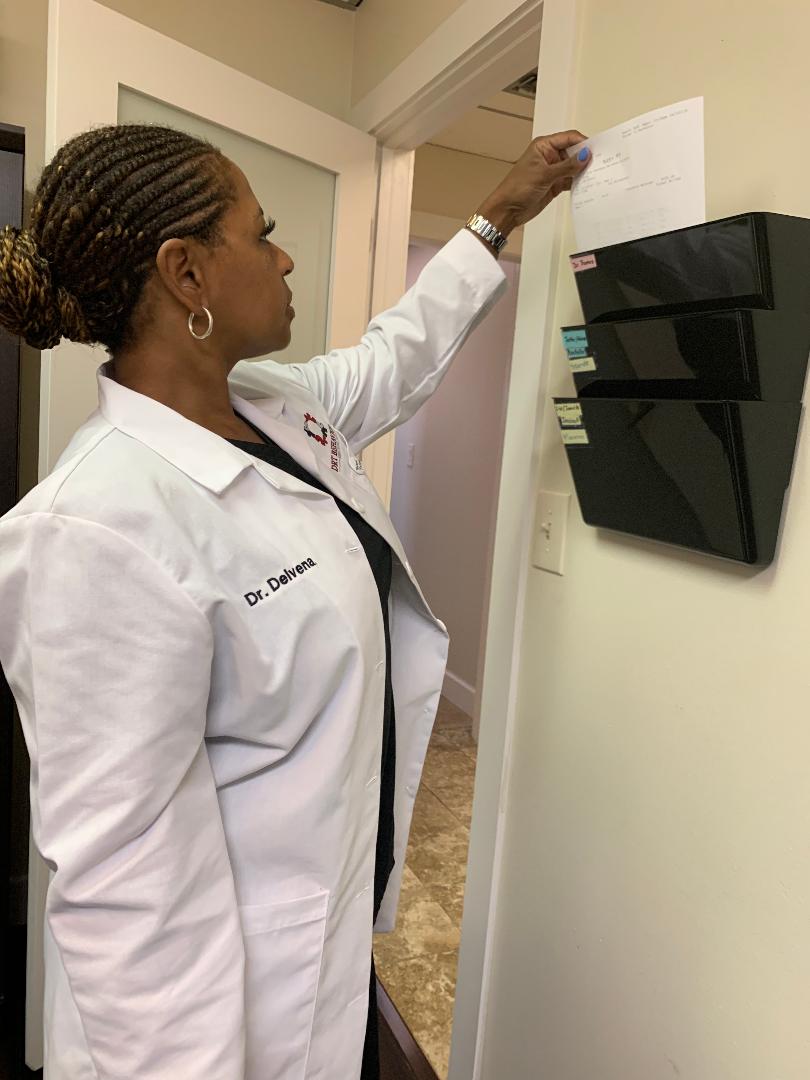 A clinician at her desk working on a computer — Dr. Delvena at DRT Behavioral Services